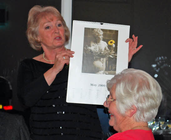 WI Calendar Girl Moira Livesey holding up a copy of the infamous calendar